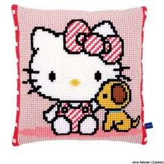 a cross - stitch pillow with a hello kitty on it's front and side