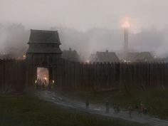 people are walking in the fog near an old wooden gate