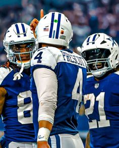 two football players giving thumbs up to each other