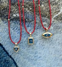 Hello, Welcome to my store ✨ If you have any questions, please contact me, i will be very happy to help you. You may want to take a look this important informations below ! ✨ 3 different shape of Blue Evil Eye 🧿Amulets with red string chain are for sale.  ✨ Pendants contain red string chain, it is 50cm (19,68inches) + 3cm adjustable chain. ✨ Gold plated, Suitable for double-sided use. ✨Mimimal collection materials are 925K good quality silver & natural gemstones & Glass Beads and very good quality rope.    ✨If you cannot find the size you are looking for, you can write to me even for your special orders; but please keep in mind; this may exceed the normal delivery time. ✨Parcels are delivered within max 2-7 days. If you need faster (1-4 days), please upgrade your shipping. Please keep in Red Pendant Charm Necklace, Spiritual Pendant Jewelry For Souvenir, Spiritual Souvenir Pendant Jewelry, Gift Amulet Charm Necklaces With Locket, Red Pendant Jewelry With Charms, Amulet Pendant Jewelry Souvenir, Good Luck Heart Charm Pendant Jewelry, Souvenir Amulet Pendant Jewelry, Souvenir Pendant Amulet Jewelry