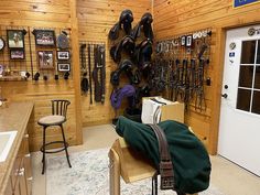 a room filled with lots of different types of hats hanging on the wall next to a door