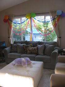 a living room filled with furniture and balloons