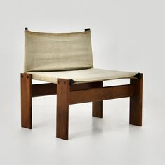 a wooden chair with a beige fabric seat pad on it's back and legs