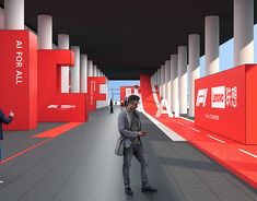 two people are standing in the middle of a red and white hallway with columns on both sides