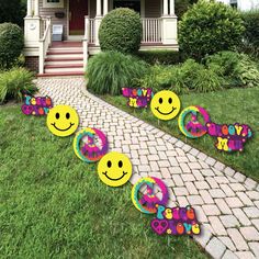 the yard has lawn decorations with smiley faces on it, along with flowers and hearts