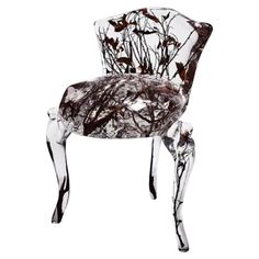 a glass chair that has been made to look like it is covered in leaves and branches