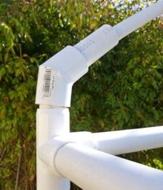 an image of a white pipe with trees in the background