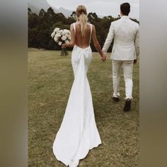 the bride and groom are walking hand in hand