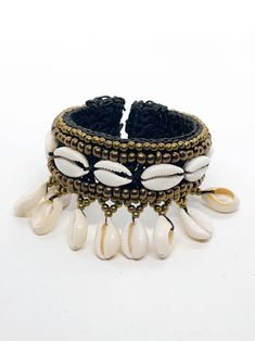 cowry and shell rattan cuff Handmade Adjustable Cuff Bracelet For Summer, Coastal Style Bracelet Jewelry For Vacation, Coastal Beach Bracelet Jewelry, Shell Bracelet Jewelry For Beach, Beaded Bracelet For Beach Season, Bohemian Shell Bracelets As Gift, Bohemian Beaded Bangle Bracelets, Bohemian Beaded Bracelets As Fashion Accessory, Adjustable Shell Jewelry For Festivals