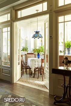 a dining room table and chairs in front of an open door