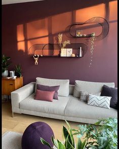 a living room filled with furniture and plants