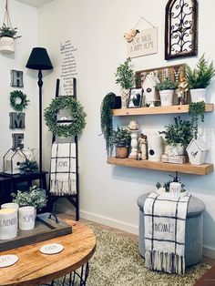 a living room filled with lots of furniture and plants on top of wooden shelving