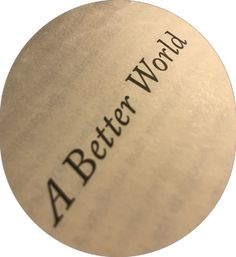 the word'a better world'written in black on a round metal object