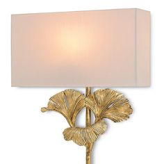 a wall lamp with a white shade on it's side and a gold leaf design