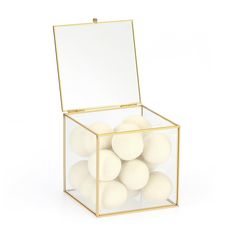 a glass box filled with white balls