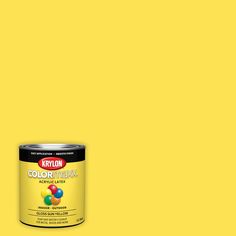 a can of yellow paint sitting on top of a table