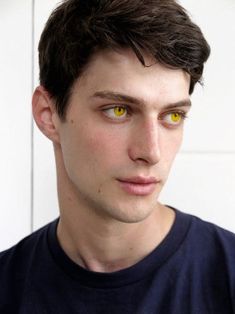 a close up of a person with yellow eyes