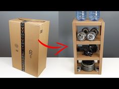 a cardboard box with two water bottles on top and a camera in the bottom shelf