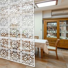 a room divider in the middle of a dining room with a table and chairs