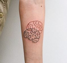 a person's arm with a tattoo on the left side of their arm and a drawing of a brain on it