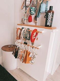 a white refrigerator freezer sitting next to a shelf filled with purses