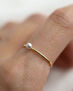 Small Swarovski Pearl Stacking Ring - It's a simple and classic everyday ring that adds a tiny beauty to your finger :) Perfect as a stacking ring or by itself. This elegant Tiny Pearl ring is made with 14K gold filled / sterling silver. ■ Tiny CZ ring can be found here: https://www.etsy.com/listing/588154122/small-diamond-cz-ring-dainty-stacking?ref=shop_home_active_1 ■ SHIPPING UPGRADES You can find shipping upgrades options in the drop bar menu when you check out. * Within the U.S Regular Fir Minimalist Adjustable Ring With Pearl Drop, Minimalist Adjustable Rings With Pearl Drop, Dainty Stackable Pearl Promise Ring, Everyday Pearl Ring With Charm, Minimalist Adjustable Pearl Drop Rings, Minimalist Adjustable Pearl Rings, Delicate Pearl Birthstone Ring, Delicate Stackable Pearl Ring For Promise, Delicate Stackable Pearl Ring As Promise Ring