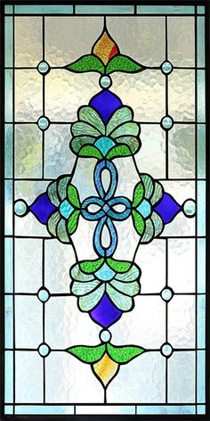 a stained glass window with an ornate design on the bottom and side panels, depicting leaves