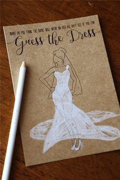 a card with a drawing of a woman in a dress on it next to a pen