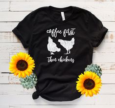 coffee first then chickens t - shirt with sunflowers next to it on a white wooden background