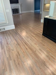 an empty living room with hard wood flooring