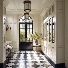 a foyer with black and white checkered flooring