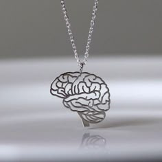 Anatomical Brain Silver Pendant, Human Brain Jewelry, Brain Pendant, 925 Silver Jewelry, Biology Jewelry ,Doctor Gift, Patient Gift ~Item Details Item- Brain Pendant Material- 925 Silver Color- Silver Pendant Without Chain  If You Want Pendant With Chain Extra Charges For Chain we also accept customize order for as per your needs. We also accept wholesale orders on wholesale value. Please contact us for wholesale orders with best price. Ready To Ship 1 To 5 Business Days We Are 24*7 Available For Our Costumers    Please Check Our Product shop Link Is here  https://www.etsy.com/shop/925silverjewls #FestiveOcassion #cyberweek #thanksgivingdecor #challenge#CHRISTMAS GIFT Bridal/Bridesmaid/Anniversary/Birthday Gift  #Birthstone Ring #Ring for woman #anxiety ring #Faster Selling Item# Bestselle Brain Aneurism, Brain Jewelry, Brain Necklace, Anatomical Jewelry, Biology Jewelry, Doctor Jewelry, Human Organ, Medical Jewelry, Pretty Jewelry Necklaces