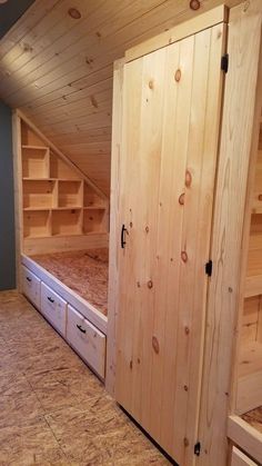 an attic bedroom with built in storage drawers