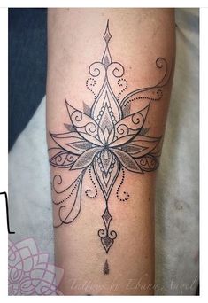 a woman's leg with a tattoo design on it