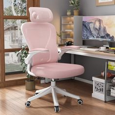 a pink office chair sitting in front of a computer desk