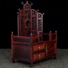 three wooden furniture pieces stacked on top of each other in front of a black background