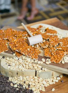 some kind of food that is on top of a cutting board with nuts and seeds