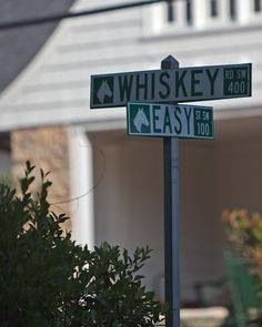 the street signs are clearly visible for us to see in this photo, which is located at the corner of whissey and east