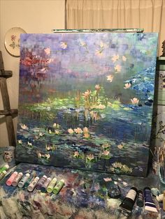 an easel is covered with water lilies and other items