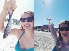 two women are on the beach and one is holding up a fish