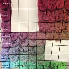 several skeins of yarn are arranged on a grid