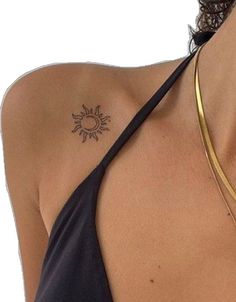 a woman with a sun tattoo on her shoulder