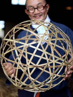 a man holding up a golden object in his hands