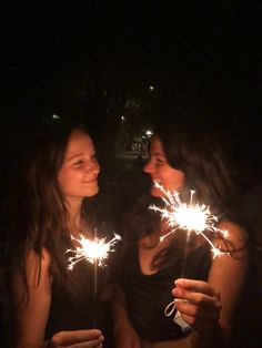 two young women holding sparklers in their hands