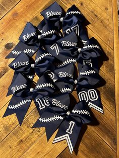 blue and white baseball ribbon with the number twenty nine on it sitting on a wooden floor