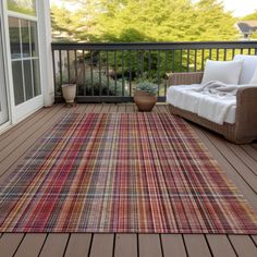 an outdoor area rug on a deck next to a couch