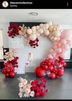 balloons and flowers are arranged on the wall