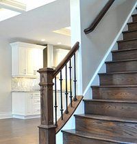 an open floor plan with stairs and cabinets