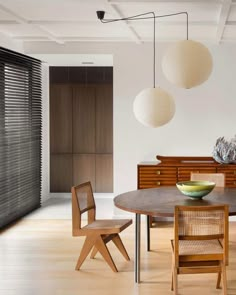 a dining room table with chairs and a bowl on it