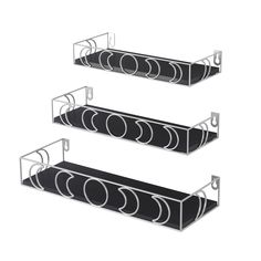 three black and white shelves with circles on them